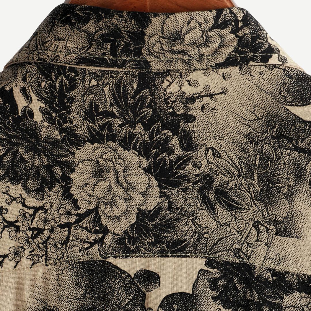 Back yoke close-up of a beige summer shirt with dense black floral pattern