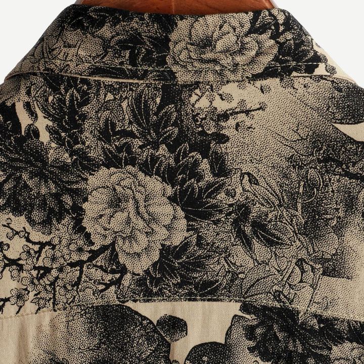Back yoke close-up of a beige summer shirt with dense black floral pattern