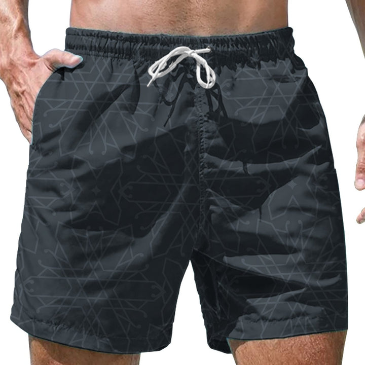 Close-up of men's black swim shorts with elastic waistband, white drawstring, and geometric pattern