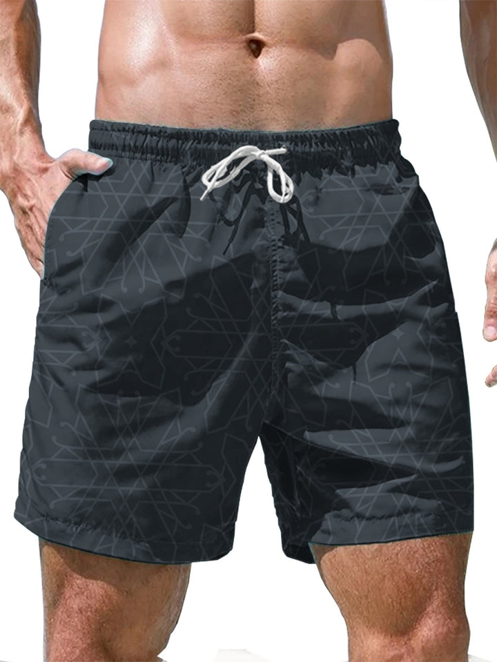Front view of black geometric swim shorts with pockets and white drawstring
