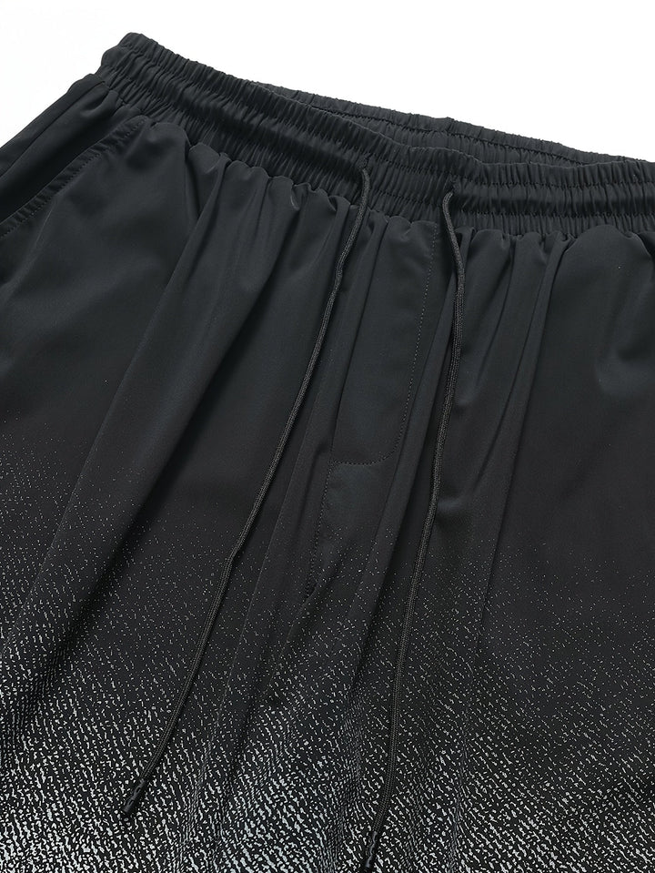 Close-up of men's swim shorts waistband, drawstring, and side pocket detail in black