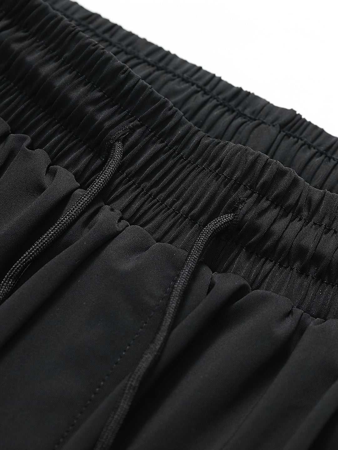 Close-up of elastic waistband and inner drawstring on men's black summer swim shorts