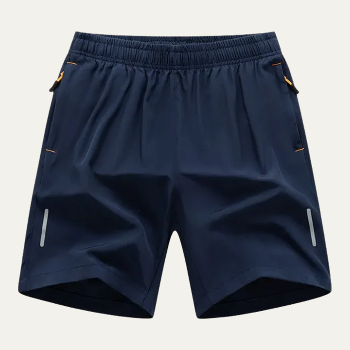 Navy blue men's running shorts with elastic waistband, zip pockets, and reflective side strips
