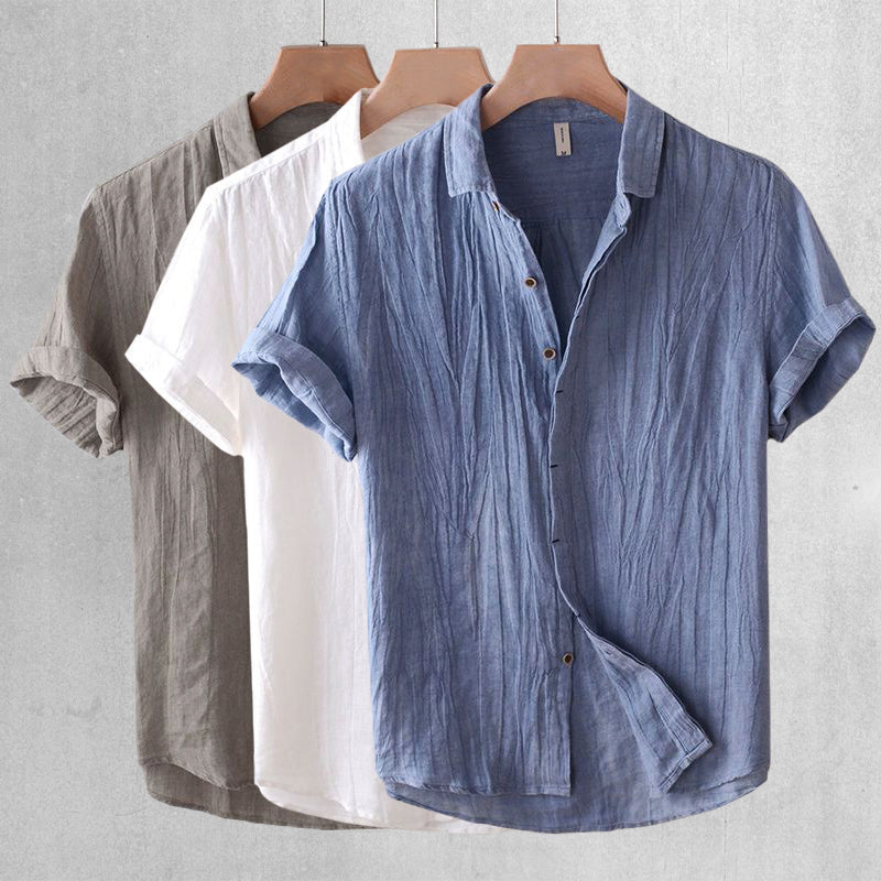 Three men's linen shirts in blue, white, and gray shown front view with short sleeves