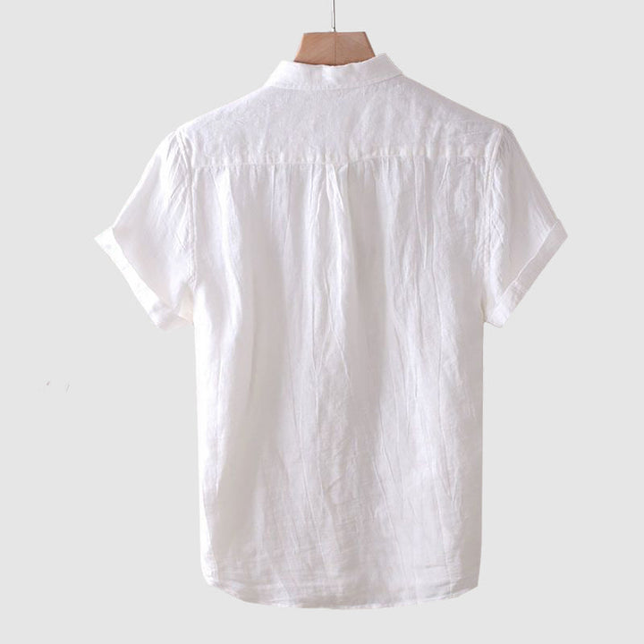 Back view of a white men's linen short sleeve shirt with a straight hem and lightweight fabric