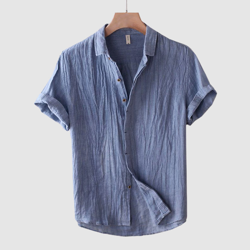 Blue men's summer linen button front short sleeve shirt with rolled cuffs and wrinkled texture