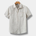 Beige men's summer linen short sleeve button up shirt with chest pocket and collared neckline