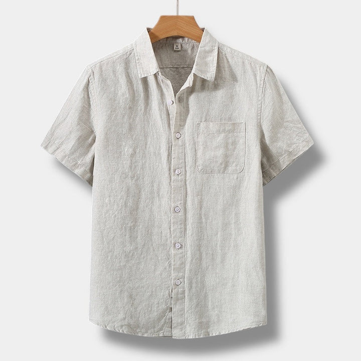 Beige men's summer linen short sleeve button up shirt with chest pocket and collared neckline