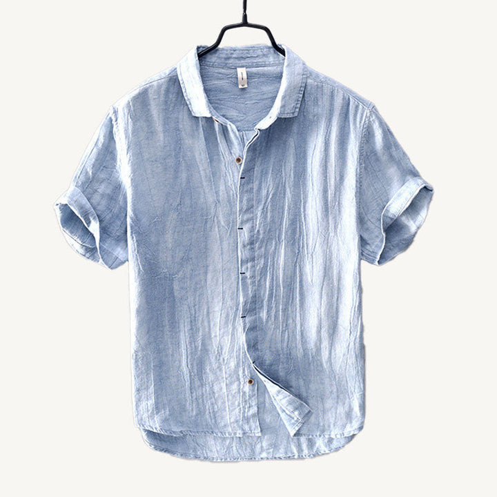 Light blue men's linen short sleeve shirt with button front and rolled cuffs