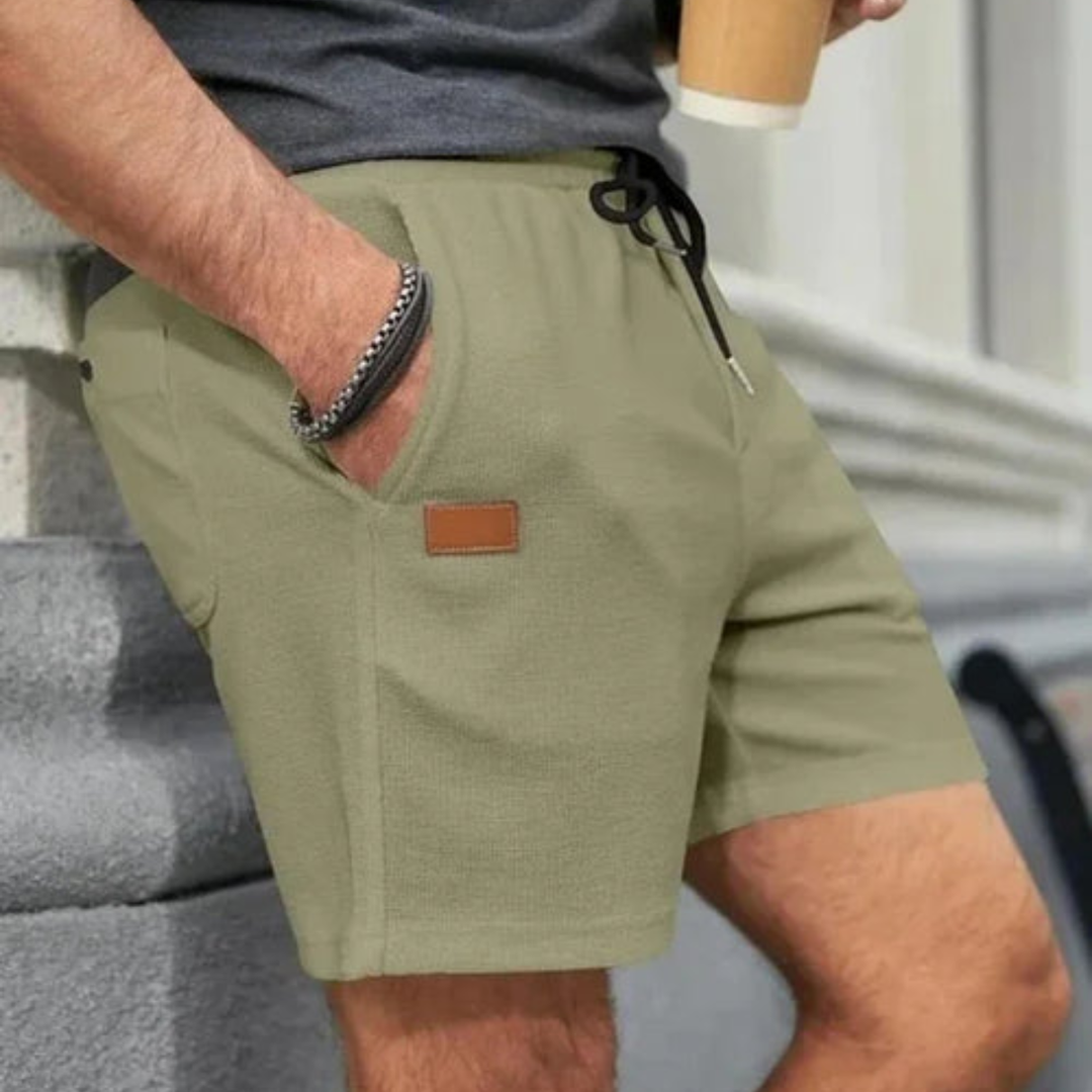 Olive green men's summer linen shorts with drawstring, side pocket detail and textured fabric