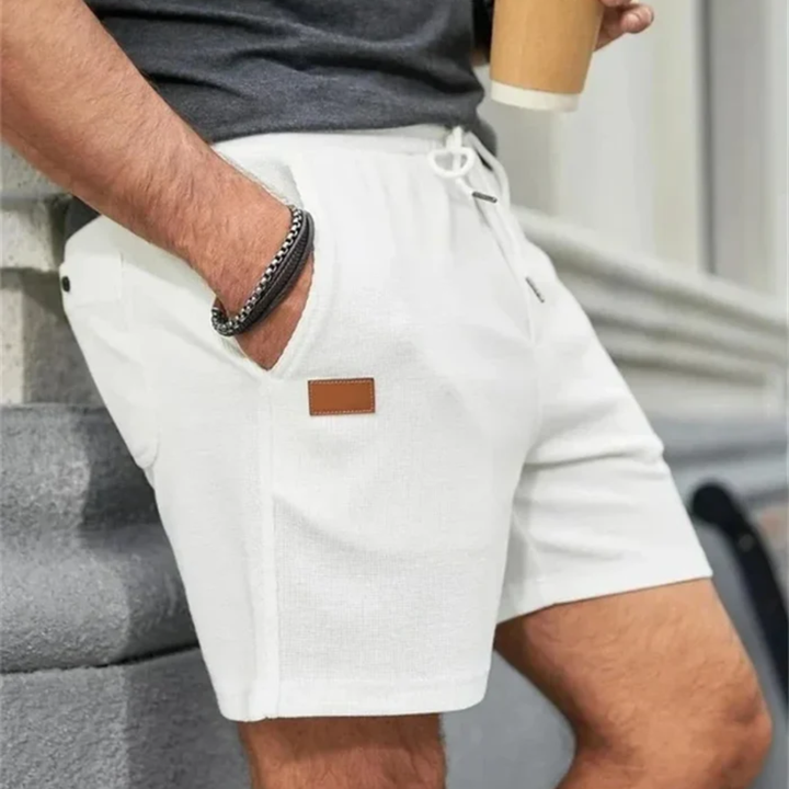 White men's linen shorts with drawstring, side pocket view and lightweight summer style