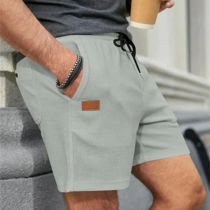 Light gray men's summer linen shorts with drawstring, side pocket detail and relaxed fit