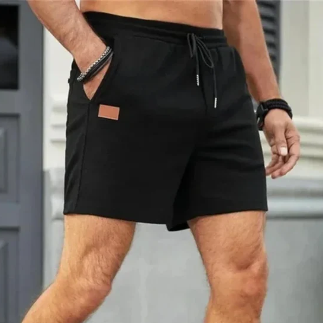 Black men's linen shorts with drawstring, front view, side pockets and casual summer style