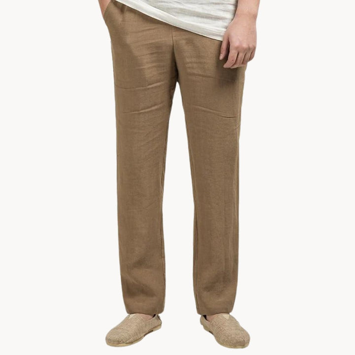 Tan straight leg linen pants for men with relaxed summer fit and woven slip-on shoes