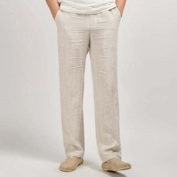 Light beige men's summer linen straight leg pants with relaxed fit and woven slip-on shoes