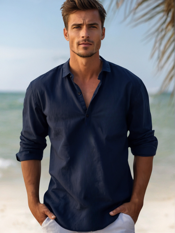 Navy linen shirt for men with V neck collar and rolled long sleeves on a beach