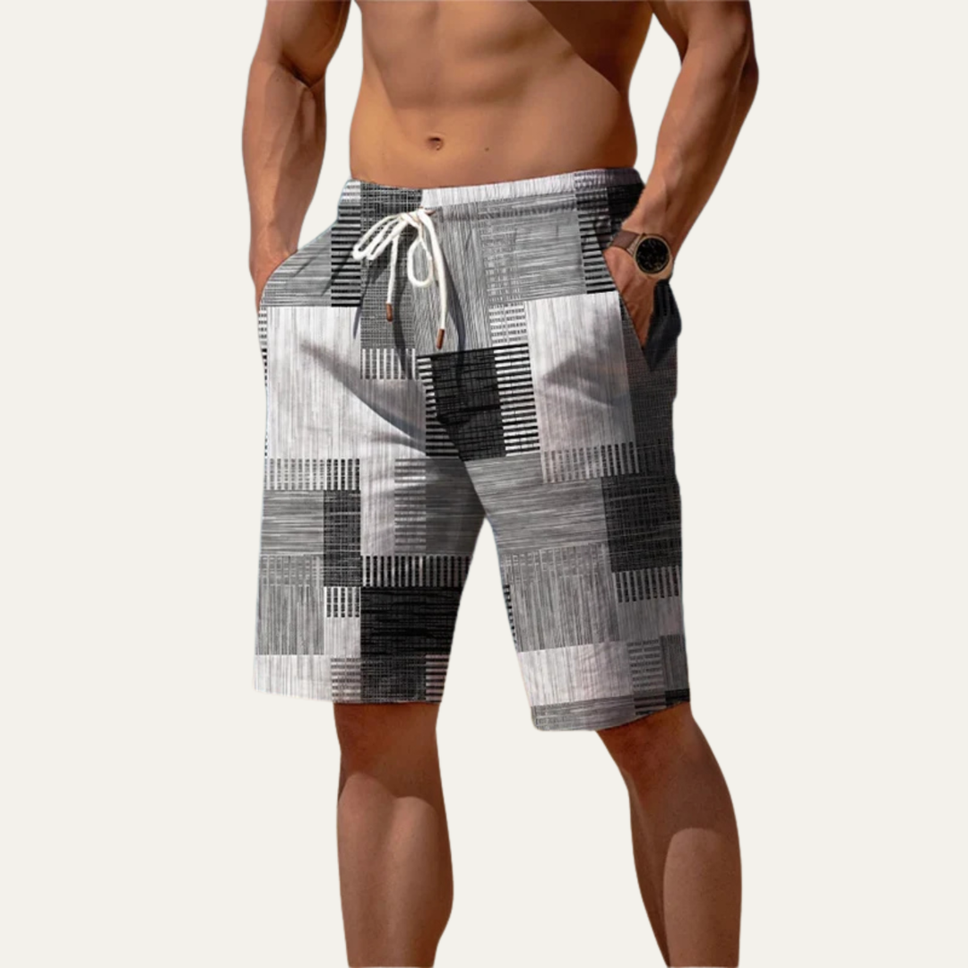 Gray and black patchwork check men's shorts shown on model with elastic waist and pockets