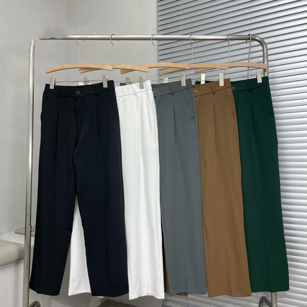 Front view of black pleated straight leg linen pants with belt loops and a clean tailored finish