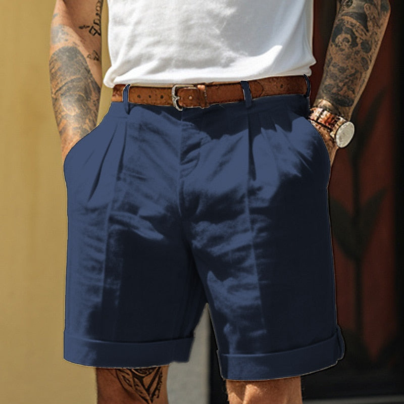 Navy blue men's pleated tailored shorts with belt, rolled cuffs and relaxed fit pockets