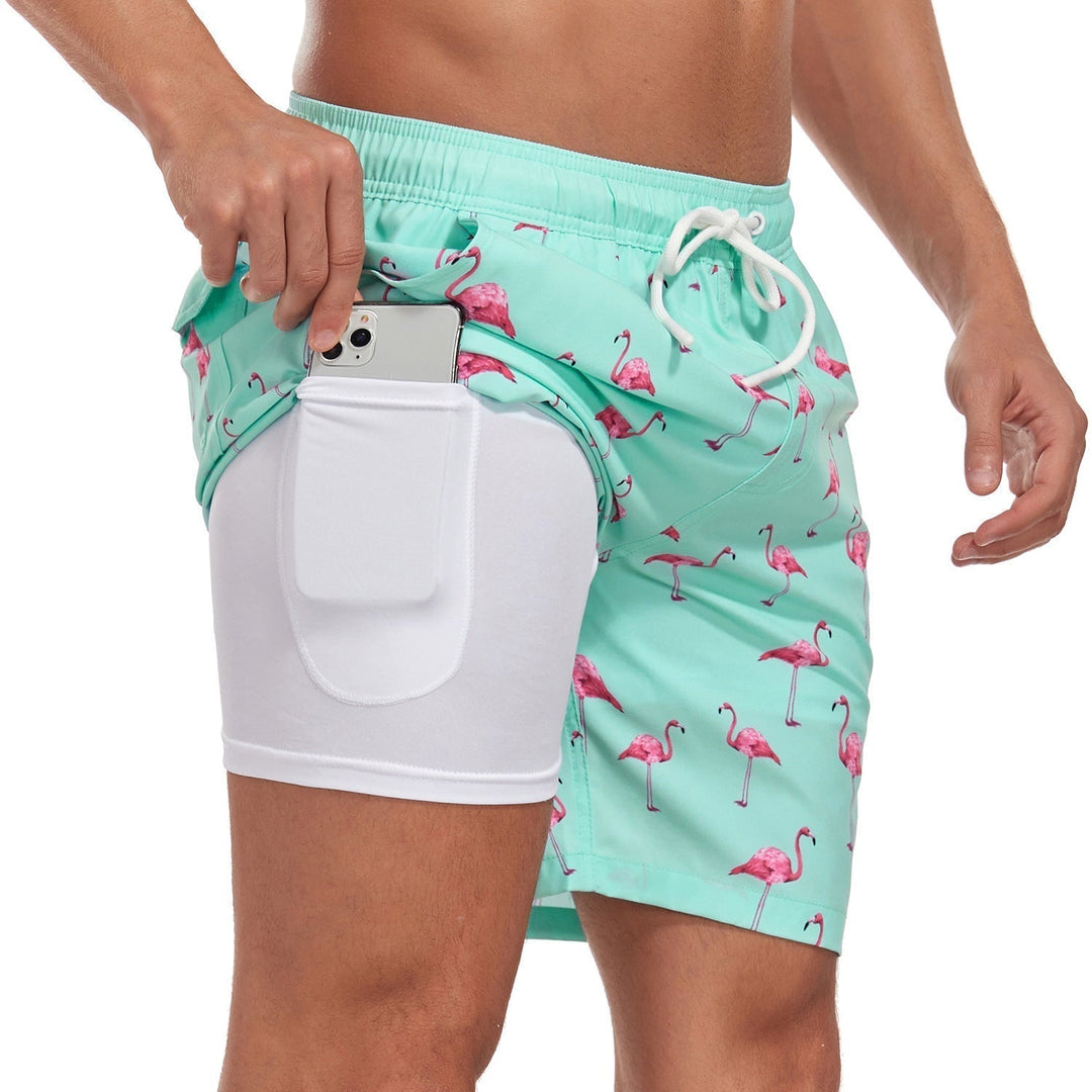 Mint green printed swim shorts with pink flamingos, drawstring waist and white lined phone pocket