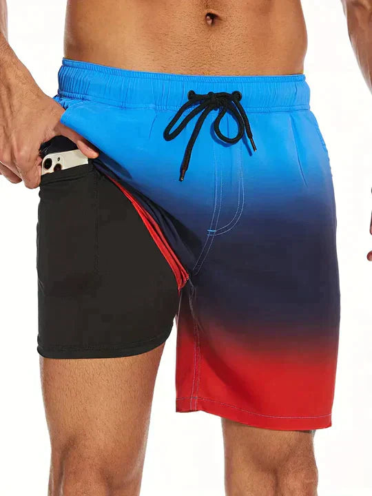 Blue to red gradient men's swim shorts with black drawstring and built-in liner shorts
