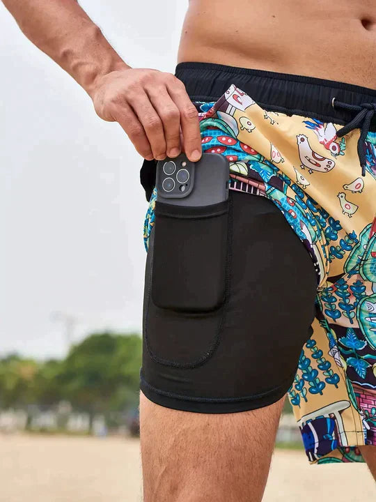 Tan cartoon print men's swim shorts with black built-in liner showing secure phone pocket