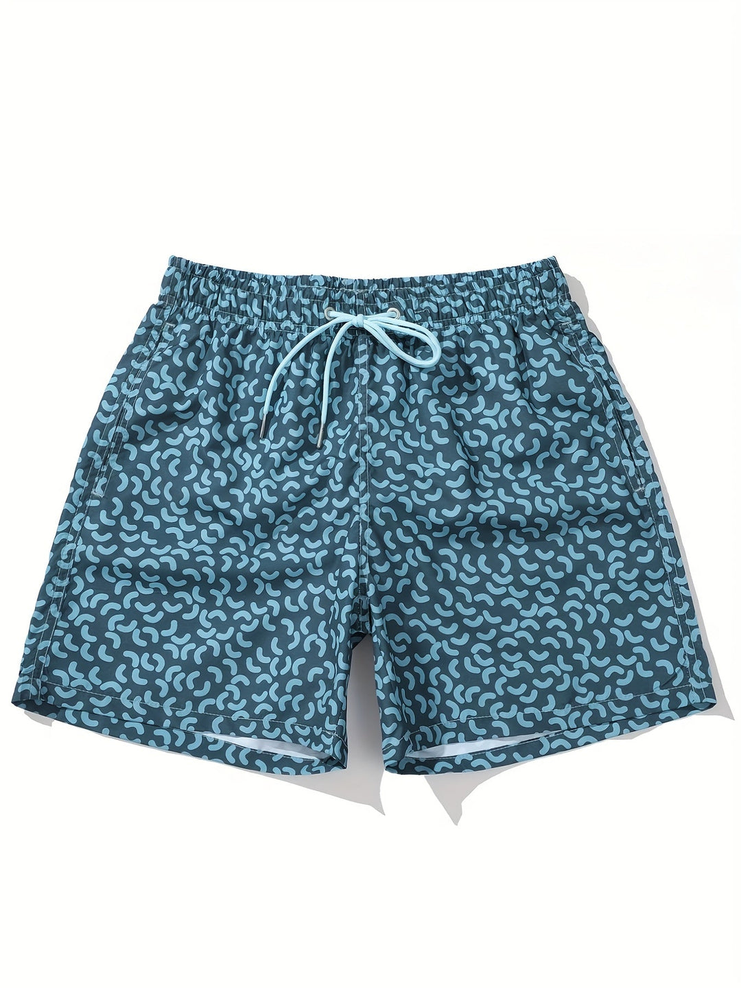 Close-up of blue men’s summer swim shorts with allover abstract print and stitched hem