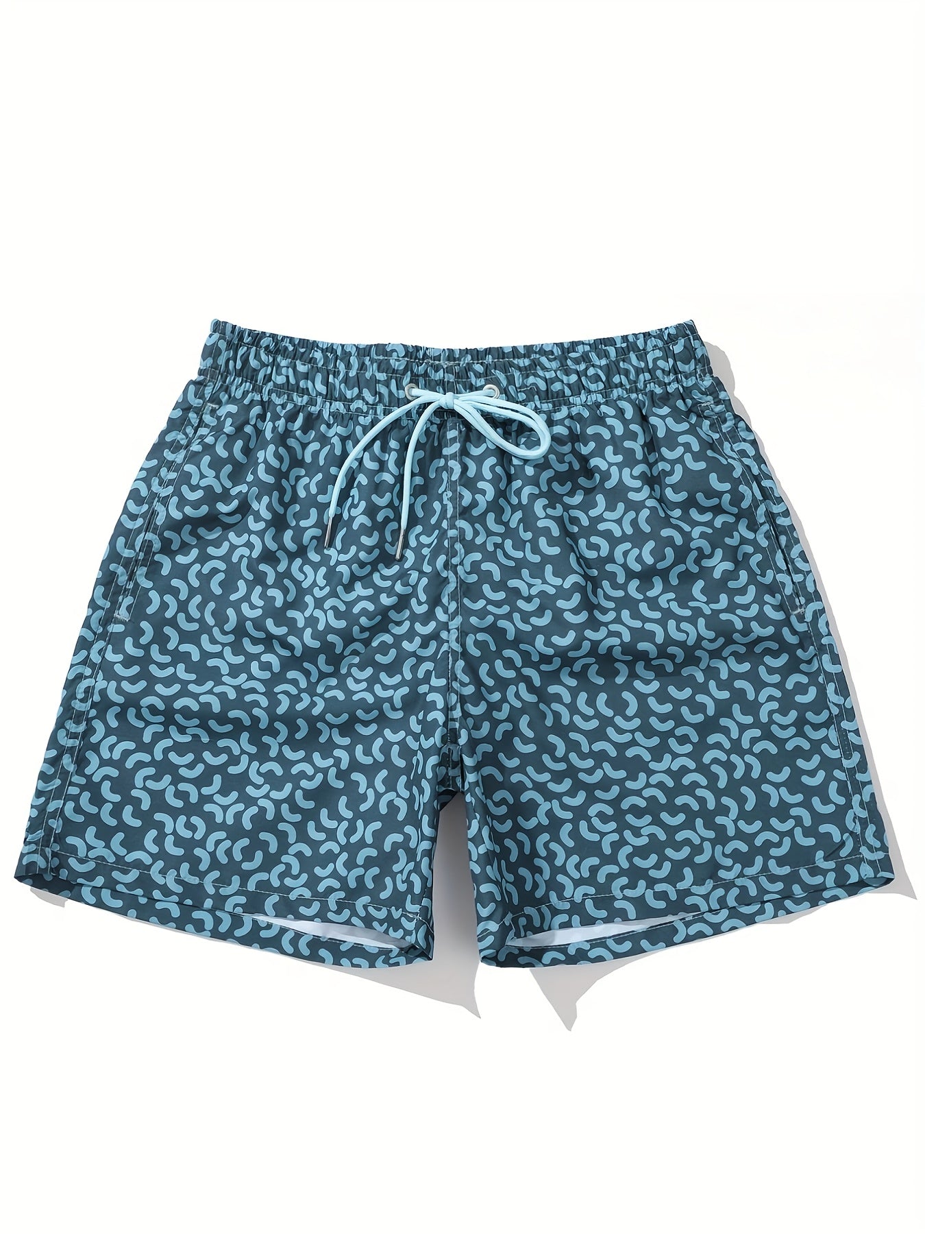 Close-up of blue men’s summer swim shorts with allover abstract print and stitched hem