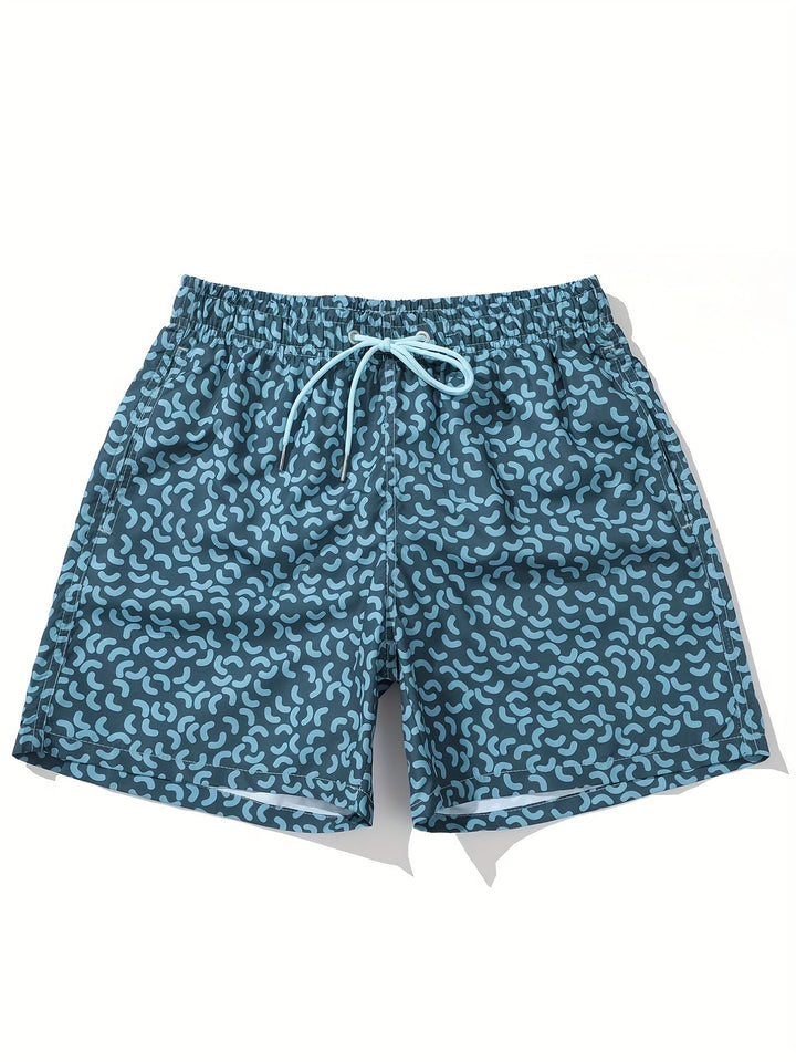 Close-up of blue men’s summer swim shorts with allover abstract print and stitched hem