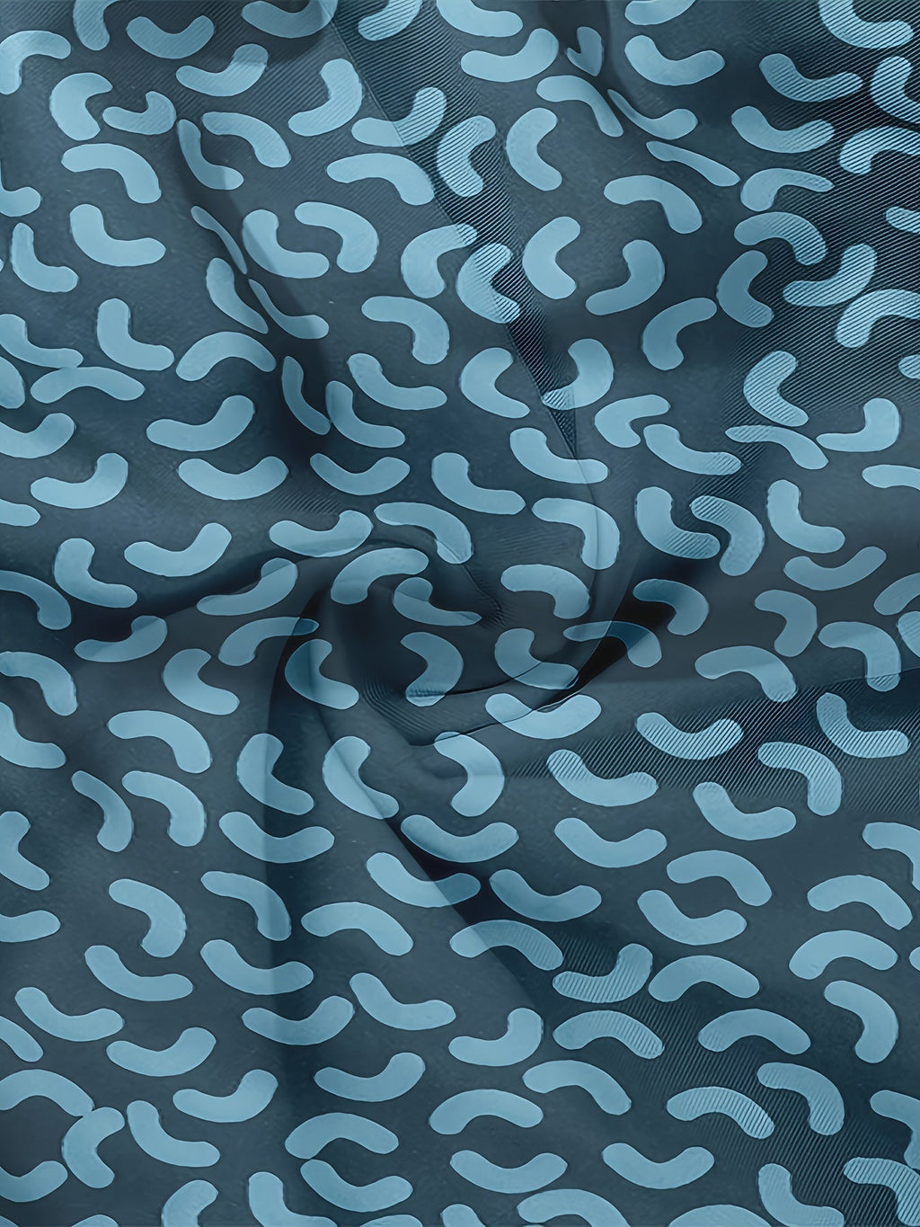 Macro detail of blue swim shorts fabric showing elastic waistband stitching and print texture