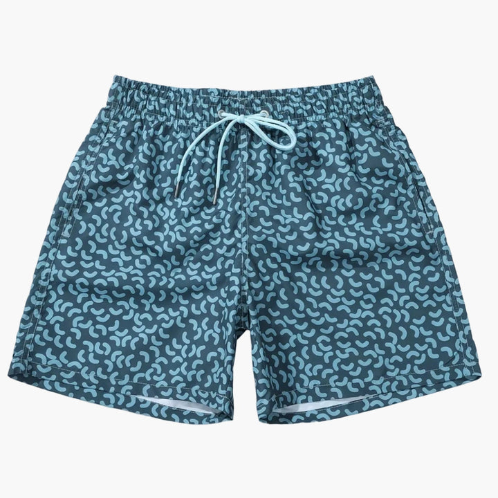 Flat lay of men’s summer printed swim shorts with elastic waist, drawstring, and abstract pattern
