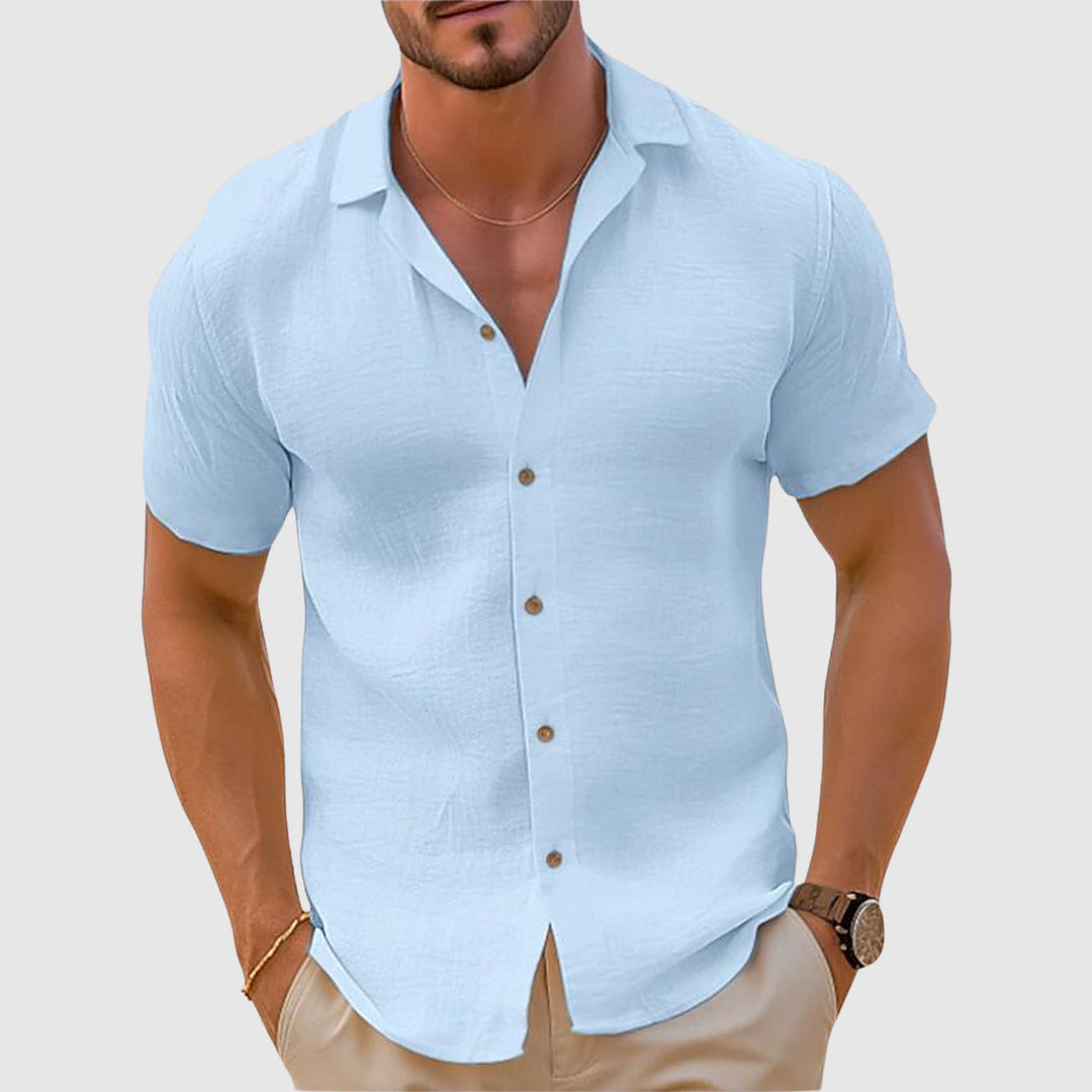 Light blue men's summer short sleeve button up shirt with soft texture and curved hem