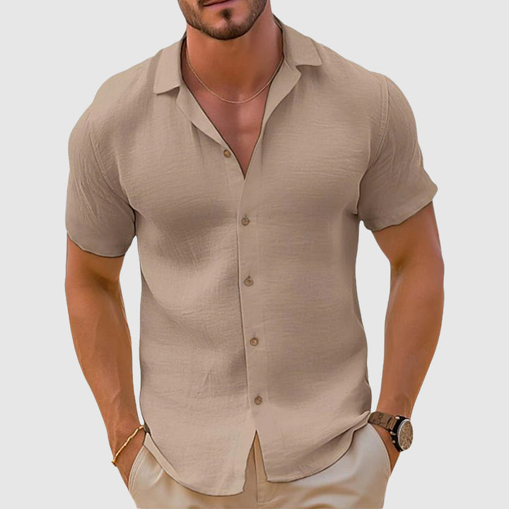 Beige men's summer short sleeve button up shirt with open collar and lightweight linen look