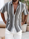 Black and white striped short sleeve button up shirt with open collar and relaxed fit