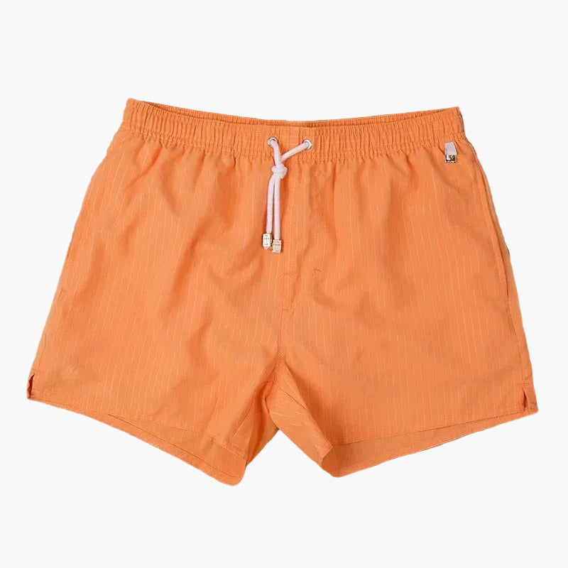 Orange swim shorts with subtle vertical texture, elastic waist, and drawstring
