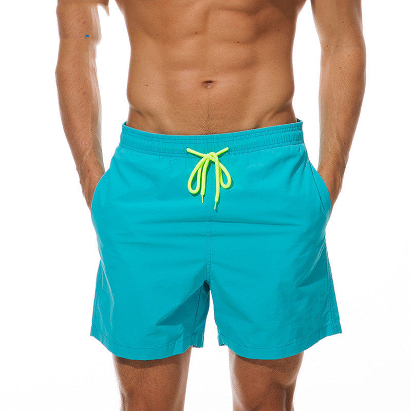 Turquoise men's swim shorts with neon green drawstring, front view summer swim shorts