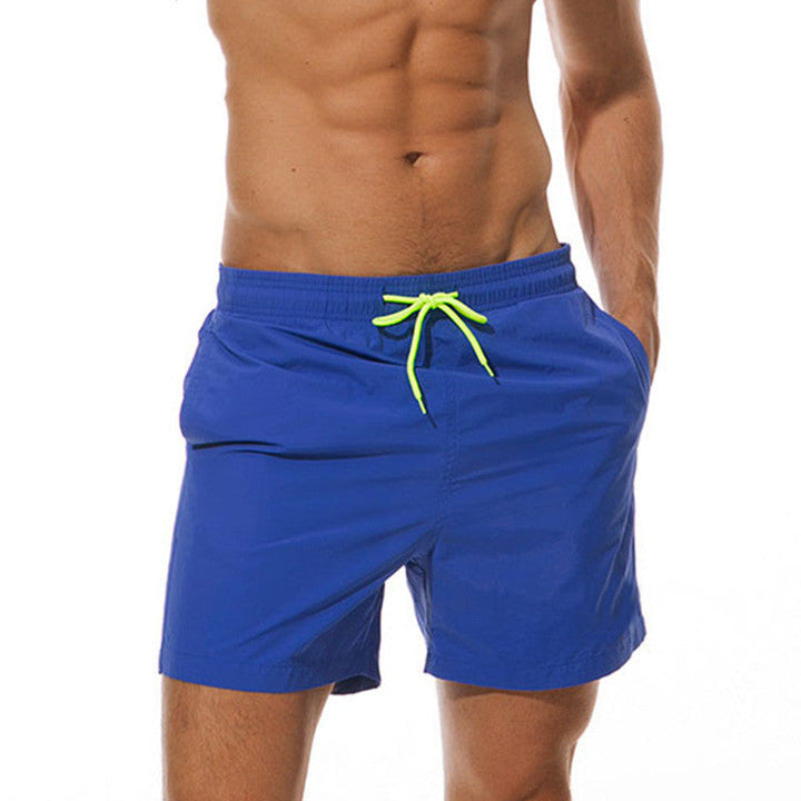 Blue men's swim shorts with neon green drawstring, front view beach bathing suit shorts