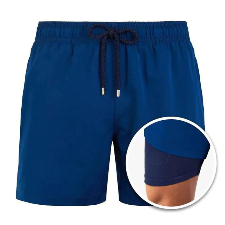 Royal blue men's swim shorts with drawstring waist and navy built-in liner shown in inset