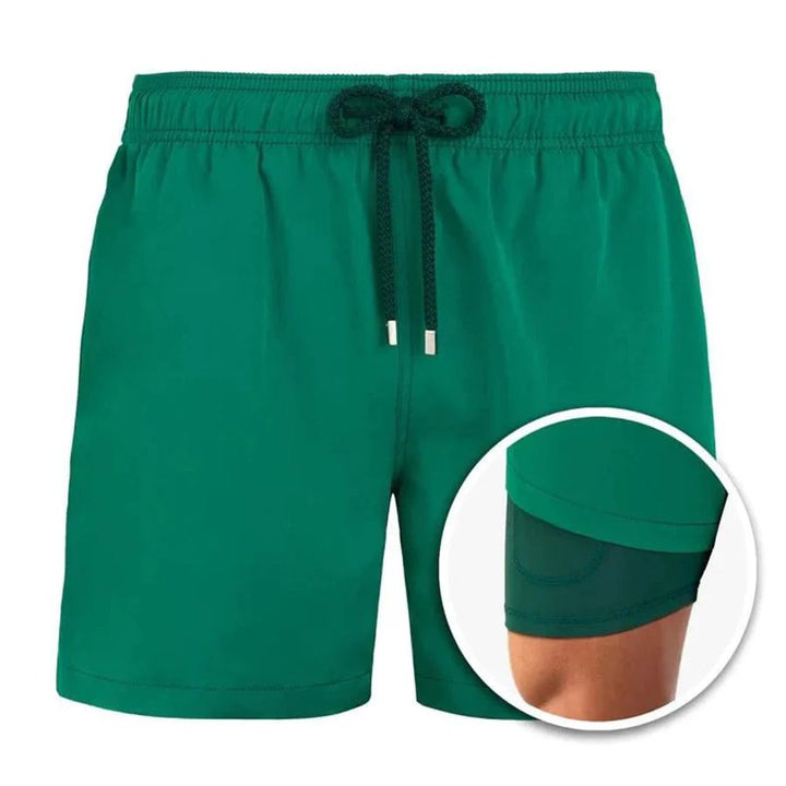 Green men's swim shorts with elastic drawstring waistband and built-in liner inset detail
