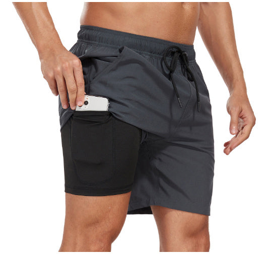 Dark gray men's swim shorts with black side pocket holding a phone