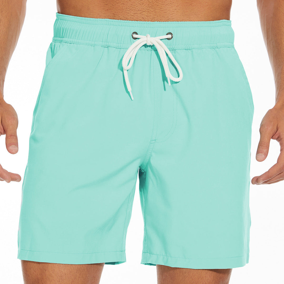 Mint green men's swim shorts with white drawstring and relaxed fit, lightweight summer shorts