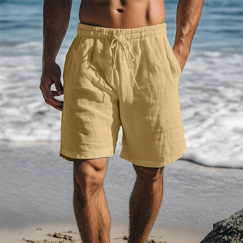 Tan men's swim shorts with pockets, drawstring waist, and casual beach style