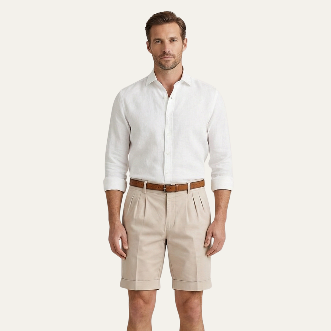 Model wearing beige men's summer tailored linen shorts with white shirt and belt