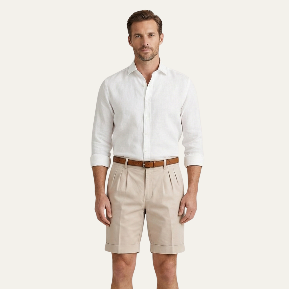 Model wearing beige men's summer tailored linen shorts with white shirt and belt