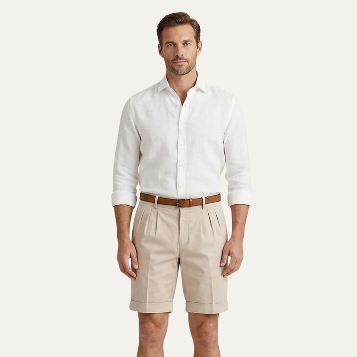 Model wearing beige men's summer tailored linen shorts with white shirt and belt