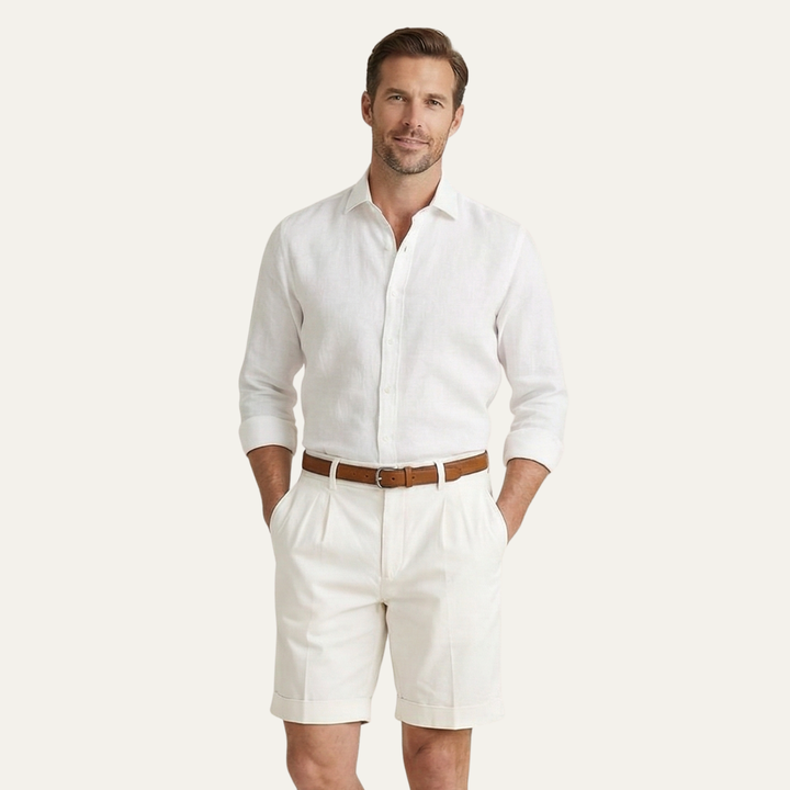Model in cream men's linen shorts styled with white shirt for summer wear