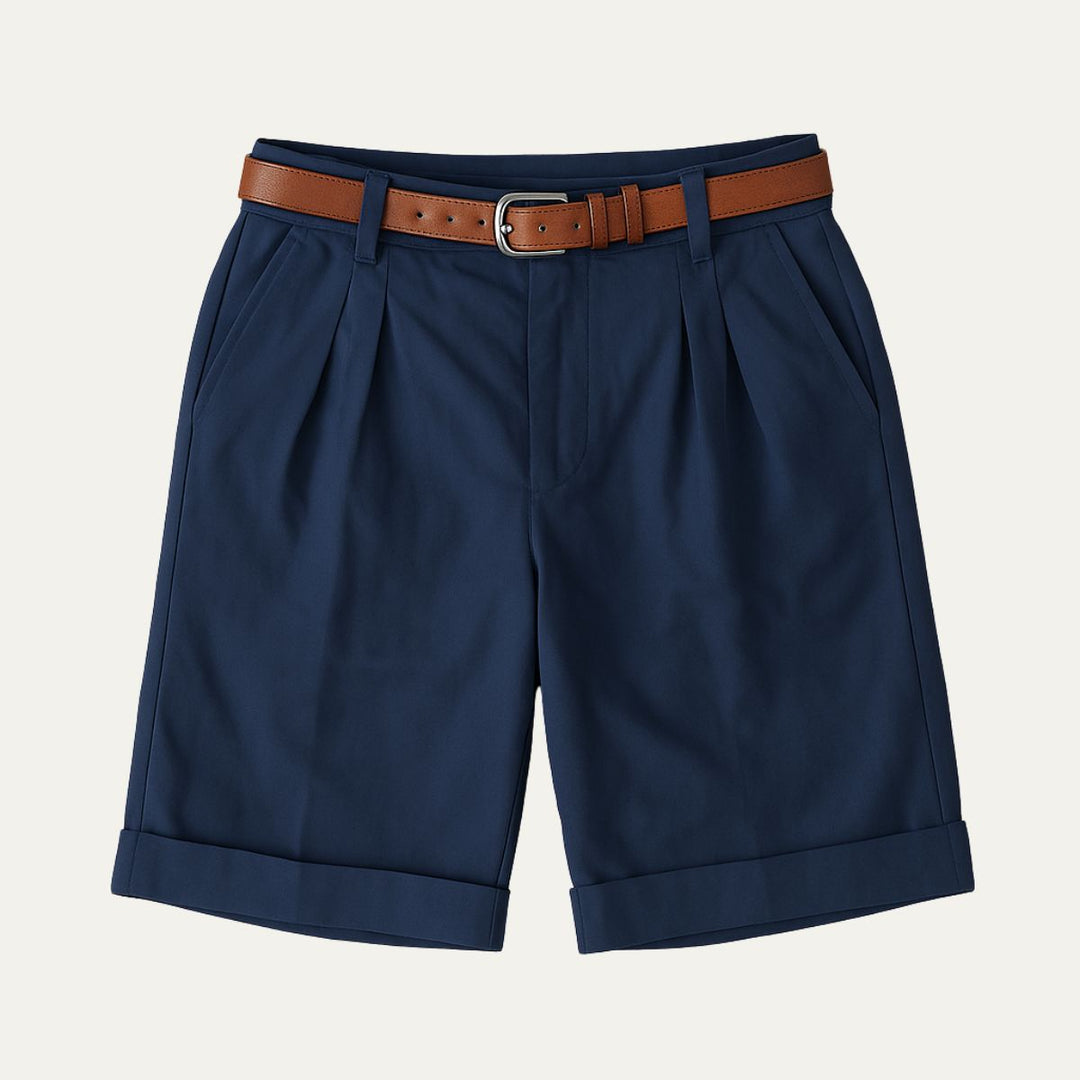 Navy tailored linen shorts with pleats, cuffed hems, and brown belt