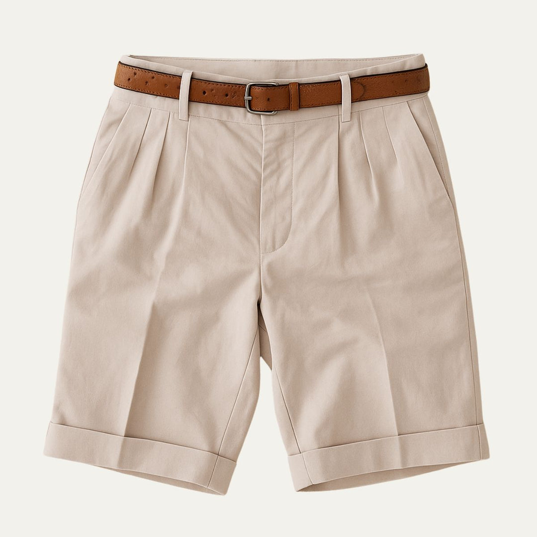 Beige tailored linen shorts with pleats, cuffed hems, and brown belt