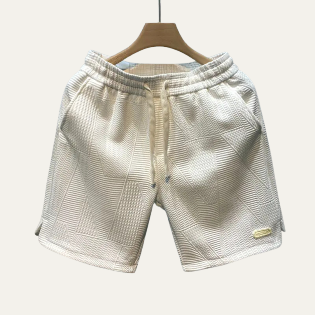Cream textured drawstring shorts for men with patchwork panels and relaxed fit