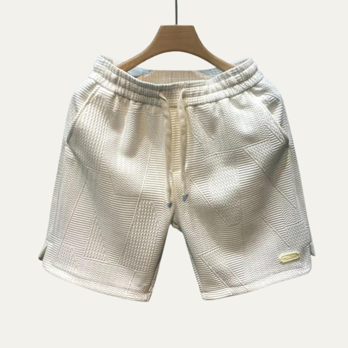 Cream textured drawstring shorts for men with patchwork panels and relaxed fit